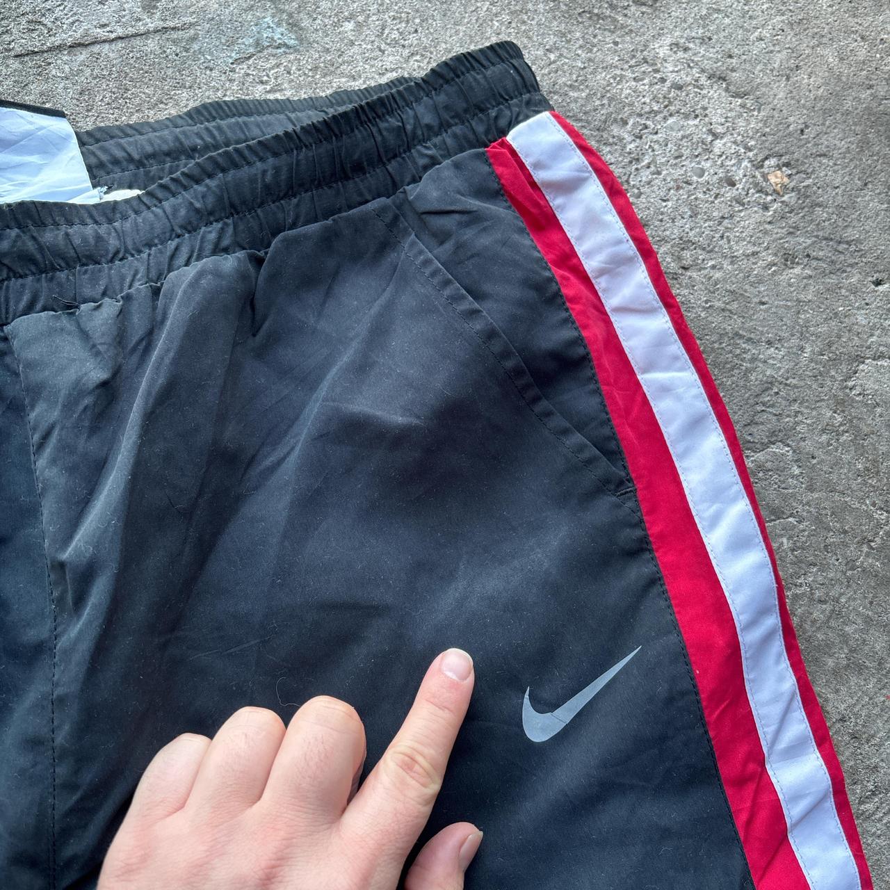 Black Nike Track pants with red and white stripes