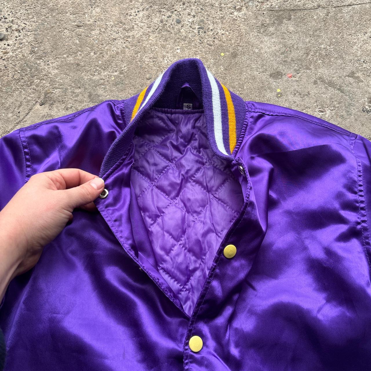 Purple bomber jacket with ‘Wonky Races’ embroidered design at the back