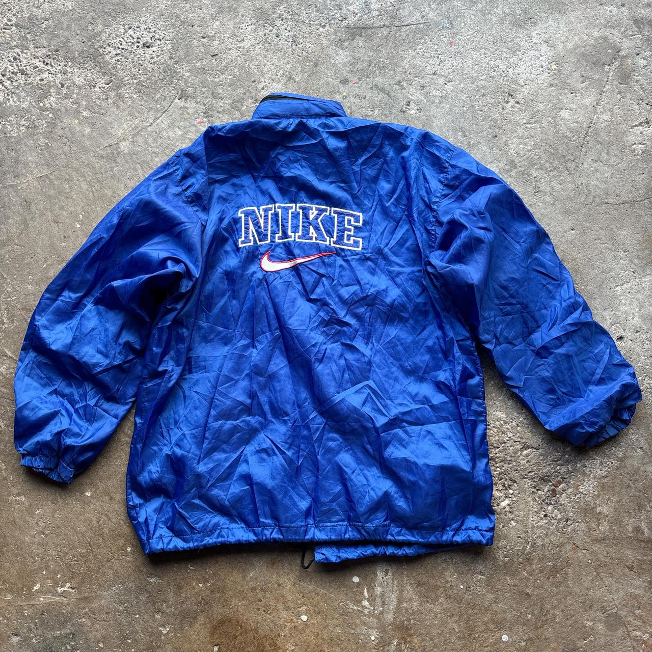 Blue Nike jacket with spell out logo