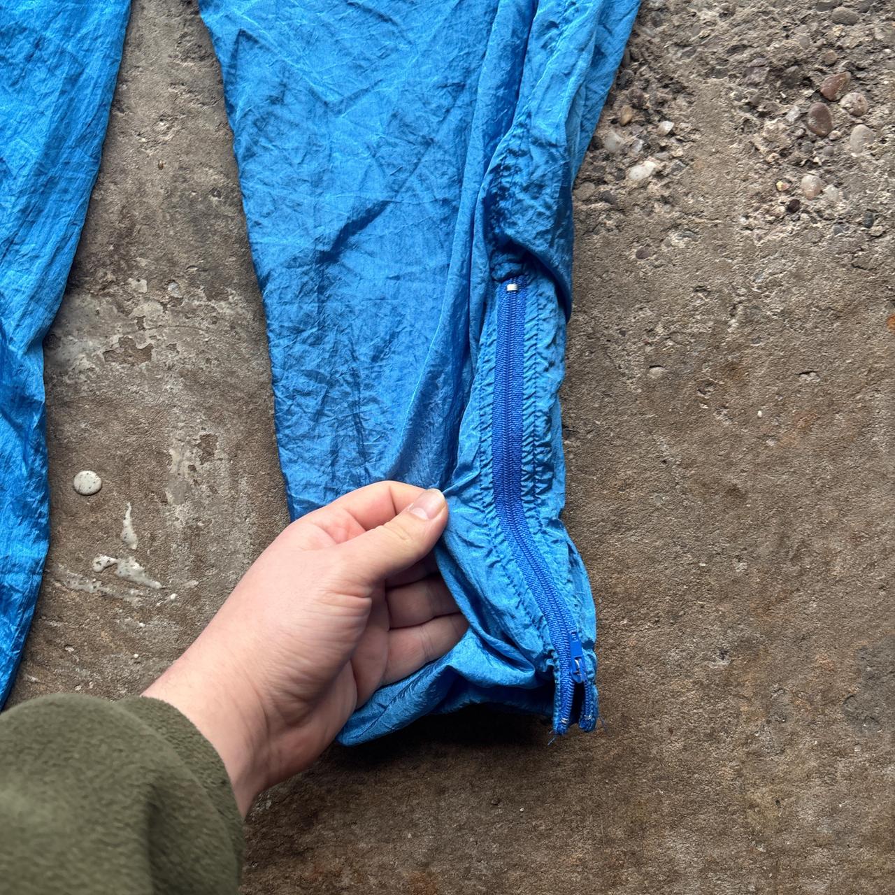 Blue vintage 80s parachute pants with elastic waist and pockets