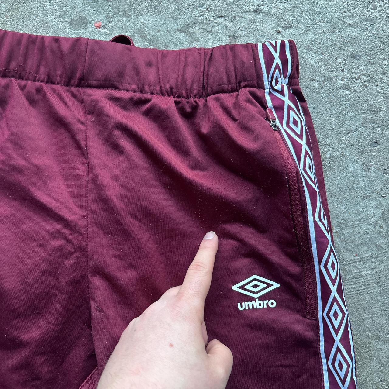 Burgundy Umbro sweatpants with stripe down the leg