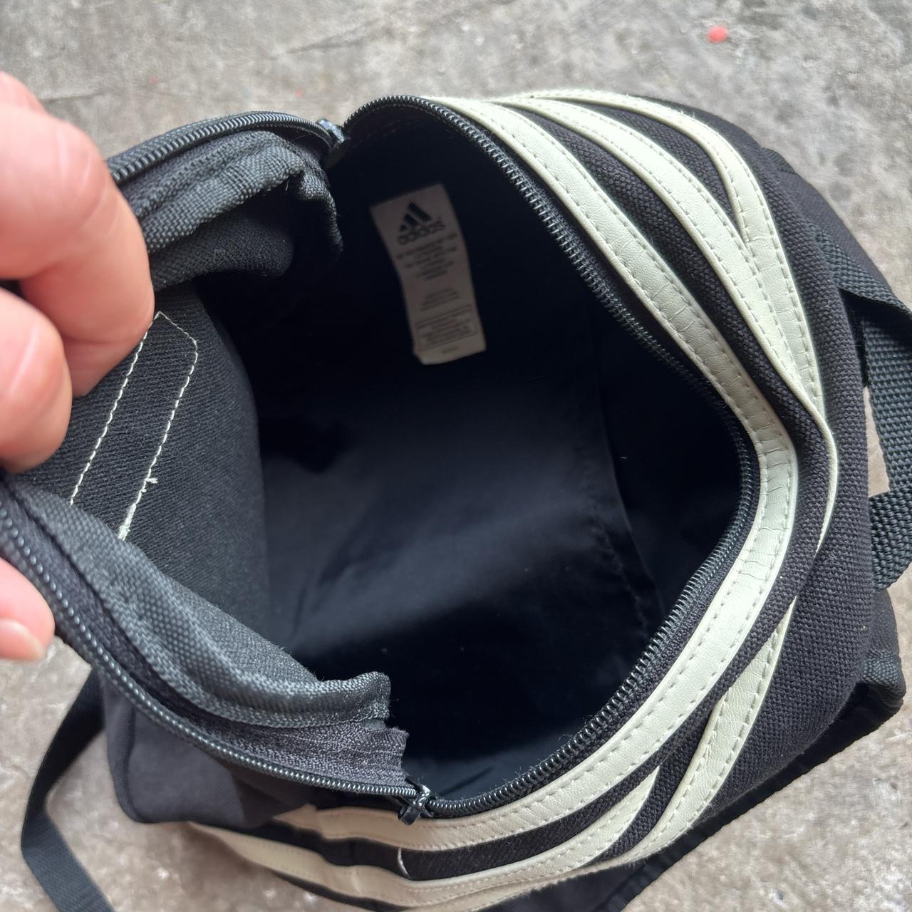 Black Adidas bag with wrap around cream stripes